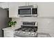 Well-equipped kitchen with stainless steel appliances including a gas range and microwave at 925 Mandolin Way, North Las Vegas, NV 89032