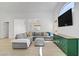 Bright living room with a large sectional sofa, hardwood floors, and modern decor at 925 Mandolin Way, North Las Vegas, NV 89032
