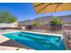 Tranquil swimming pool with an integrated waterfall feature, surrounded by a manicured backyard and stylish hardscaping at 925 Mandolin Way, North Las Vegas, NV 89032