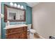 Stylish half bathroom with intricate wood vanity, decorative mirror, and elegant fixtures at 9270 Apache Springs Dr, Las Vegas, NV 89117