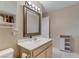 Bright bathroom featuring a large mirror, neutral color palette, and storage cabinet at 9270 Apache Springs Dr, Las Vegas, NV 89117