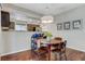 Cozy dining area features a round wood table, chandelier, and view of the kitchen with stainless steel appliances at 9270 Apache Springs Dr, Las Vegas, NV 89117