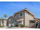 Attractive exterior displaying a townhome featuring a well-maintained facade, a two-car garage and desert landscaping at 9270 Apache Springs Dr, Las Vegas, NV 89117
