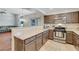 Kitchen features stainless steel appliances, granite countertops, and stylish brown cabinets at 9270 Apache Springs Dr, Las Vegas, NV 89117