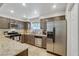 Bright kitchen features stainless steel appliances, granite countertops, and light tile flooring at 9270 Apache Springs Dr, Las Vegas, NV 89117