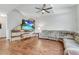 Modern living room with a TV, hardwood floors, and neutral tones, creating a perfect space for entertaining at 9270 Apache Springs Dr, Las Vegas, NV 89117