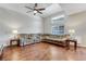 Spacious living room featuring hardwood floors, a ceiling fan, and natural light, perfect for Gathering gatherings at 9270 Apache Springs Dr, Las Vegas, NV 89117