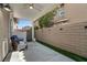 Covered patio with seating, brick wall, and partial turf at 9270 Apache Springs Dr, Las Vegas, NV 89117