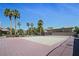 Beautiful tennis court features well-maintained nets and mature palm trees, enhancing a pleasant outdoor experience at 9270 Apache Springs Dr, Las Vegas, NV 89117