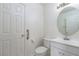 Clean half bathroom with a white sink and toilet, featuring a grab bar for accessibility at 9709 Casper Peak Ct, Las Vegas, NV 89117