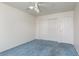 Bedroom features blue carpet, a ceiling fan, and closet space at 9709 Casper Peak Ct, Las Vegas, NV 89117