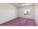 Bedroom featuring pink carpet, a ceiling fan, and a window offering a view of neighboring homes at 9709 Casper Peak Ct, Las Vegas, NV 89117