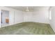 Spacious bedroom with green carpet, a ceiling fan, and closet space at 9709 Casper Peak Ct, Las Vegas, NV 89117