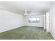 Bedroom with green carpet, a ceiling fan, and a window offering a view of neighboring homes at 9709 Casper Peak Ct, Las Vegas, NV 89117