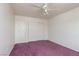 Bedroom features pink carpet, a ceiling fan, and closet space at 9709 Casper Peak Ct, Las Vegas, NV 89117