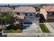 Charming two-story home with a well-manicured lawn, mature tree, and three-car garage at 9709 Casper Peak Ct, Las Vegas, NV 89117