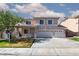 Inviting two-story home features a three-car garage, manicured lawn, and desert landscaping at 9709 Casper Peak Ct, Las Vegas, NV 89117