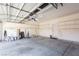 Spacious two-car garage with overhead lighting, shelving, and ample storage space at 9709 Casper Peak Ct, Las Vegas, NV 89117