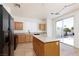Bright kitchen with an island, black appliances and sliding door access to the backyard at 9709 Casper Peak Ct, Las Vegas, NV 89117