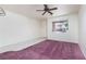 Spacious living room with lots of natural light, a ceiling fan, and tile/carpet flooring at 9709 Casper Peak Ct, Las Vegas, NV 89117