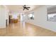 Spacious living room featuring wood floors, ceiling fan, and natural light from the windows at 9709 Casper Peak Ct, Las Vegas, NV 89117