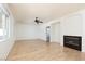 Open-concept living room with hardwood floors, fireplace, and an open entry to a bathroom at 9709 Casper Peak Ct, Las Vegas, NV 89117