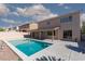 Backyard with a sparkling pool, covered patio, and desert landscaping at 9709 Casper Peak Ct, Las Vegas, NV 89117