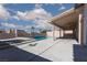Backyard pool area with steps and a covered patio with ceiling fans at 9709 Casper Peak Ct, Las Vegas, NV 89117
