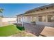 Spacious backyard with covered patio, artificial grass, and desert landscaping at 1006 Blue Lantern Dr, Henderson, NV 89015