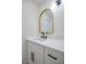 Stylish bathroom featuring a sleek vanity with quartz countertop and gold-framed mirror at 1006 Blue Lantern Dr, Henderson, NV 89015