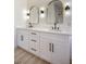 Bathroom vanity featuring double sinks with black hardware and gold framed mirrors at 1006 Blue Lantern Dr, Henderson, NV 89015