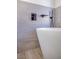 Contemporary bathtub featuring sleek fixtures and tiled walls at 1006 Blue Lantern Dr, Henderson, NV 89015