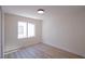 Bright bedroom with wood-look flooring, a window, and neutral paint at 1006 Blue Lantern Dr, Henderson, NV 89015