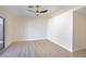 Well-lit bedroom featuring wood-look floors, neutral paint, a fan, and a sliding glass door at 1006 Blue Lantern Dr, Henderson, NV 89015