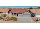 Charming single-story home featuring a red tile roof, a two-car garage, and desert landscaping in a quiet neighborhood at 1006 Blue Lantern Dr, Henderson, NV 89015