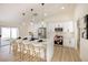Modern kitchen with white cabinets, stainless steel appliances, and an island with seating, perfect for casual dining at 1006 Blue Lantern Dr, Henderson, NV 89015