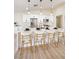 Bright, open kitchen featuring white cabinets, an island with seating, and stainless steel appliances for modern convenience at 1006 Blue Lantern Dr, Henderson, NV 89015