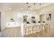 Modern kitchen featuring white cabinetry, stainless steel appliances, a quartz countertop island, and stylish pendant lighting at 1006 Blue Lantern Dr, Henderson, NV 89015