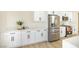 Bright kitchen featuring white cabinets, quartz countertops, and stainless steel appliances at 1006 Blue Lantern Dr, Henderson, NV 89015