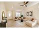 Cozy living room featuring stylish seating, a console table with a mirror, and a window with a view of the neighborhood at 1006 Blue Lantern Dr, Henderson, NV 89015