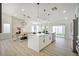 Open living and dining space with modern island, quartz countertops and backyard access at 1006 Blue Lantern Dr, Henderson, NV 89015