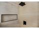 Modern shower featuring neutral tile and rainfall showerhead with built-in niche at 1006 Blue Lantern Dr, Henderson, NV 89015