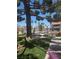 View of a condo complex featuring lush landscaping with tropical palm trees surrounding the community in a vibrant setting at 101 Luna Way # 104, Las Vegas, NV 89145