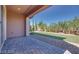 The tiled patio overlooks an expansive backyard with mature landscaping and synthetic grass at 10342 Kesington Dr, Las Vegas, NV 89135