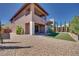 The backyard features rock landscaping, a synthetic grass area, and low maintenance features at 10342 Kesington Dr, Las Vegas, NV 89135