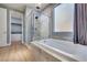 Modern bathroom featuring a soaking tub and separate glass-enclosed shower at 10342 Kesington Dr, Las Vegas, NV 89135