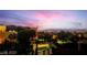 Sunset views of the city, and community landscaping beyond a metal railing at 10342 Kesington Dr, Las Vegas, NV 89135