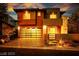 Inviting two-story home at dusk, with a glass garage door and warm lighting at 10342 Kesington Dr, Las Vegas, NV 89135