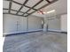 View of the spacious two car garage with a water softener, water heater, and storage racks at 10342 Kesington Dr, Las Vegas, NV 89135