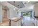 Open-concept kitchen featuring stainless steel appliances, a large island, and bright lighting at 10342 Kesington Dr, Las Vegas, NV 89135